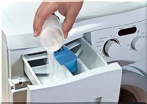 Pouring the washing powder into the washing machine