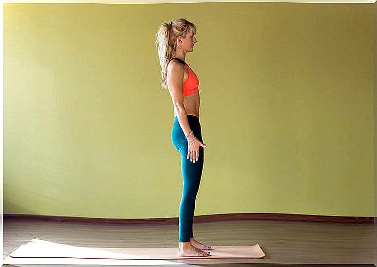 The woman is exercising on the mat