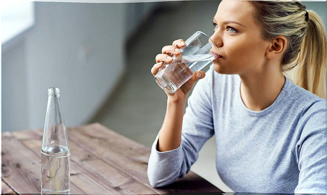 A woman drinking water to improve blood circulation in the legs