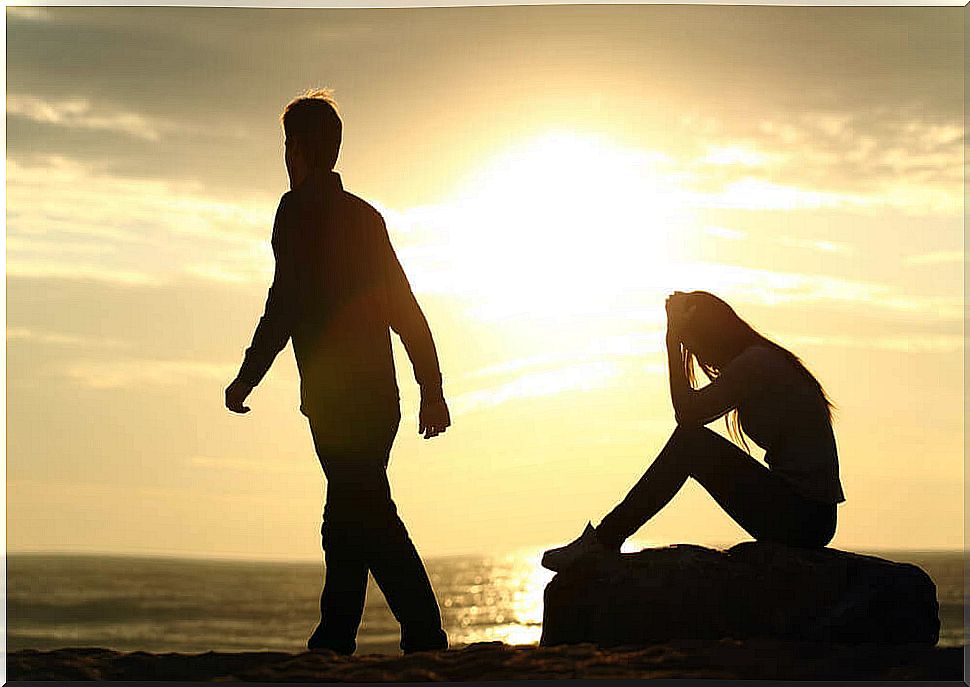 Couple by the sea at sunset