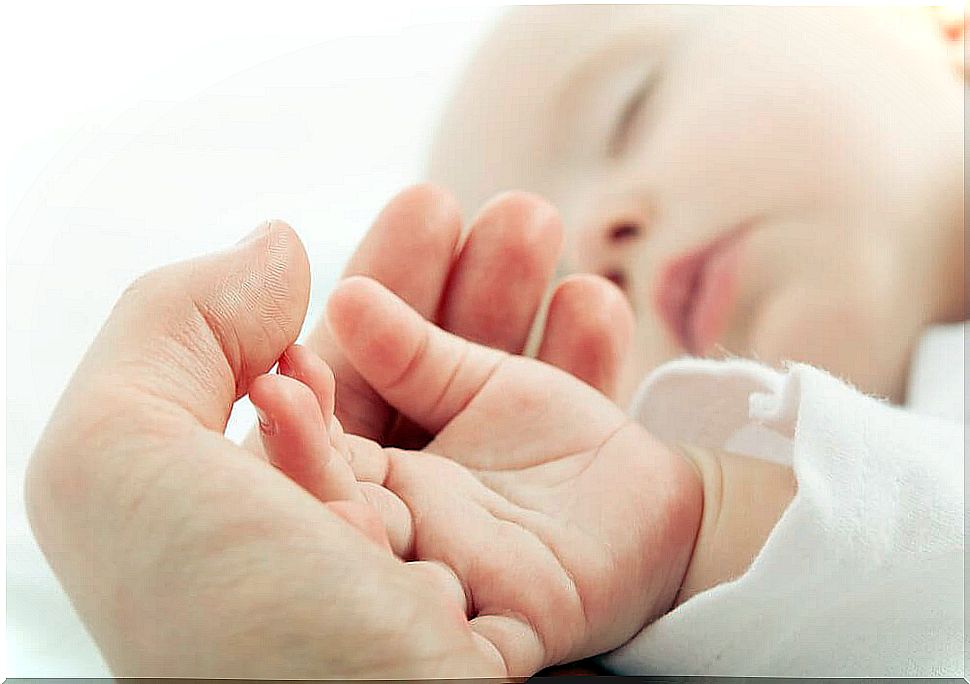 Mom is holding the baby's handle