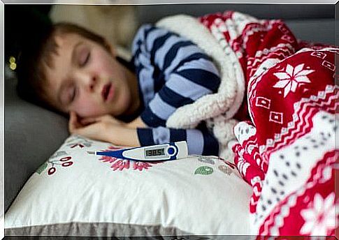 The baby is sleeping with a thermometer