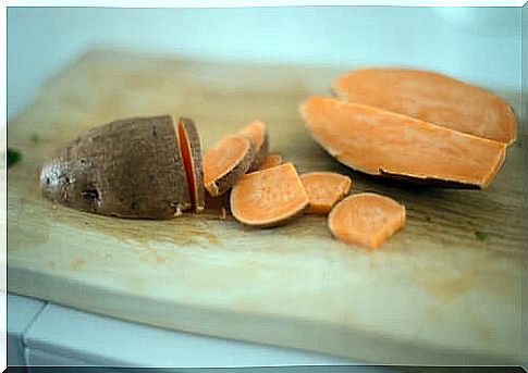 Sweet potatoes on wooden board