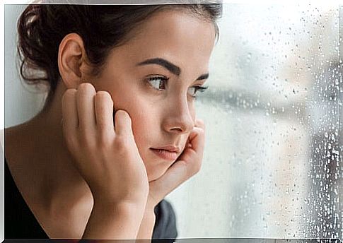 Sad woman by the window